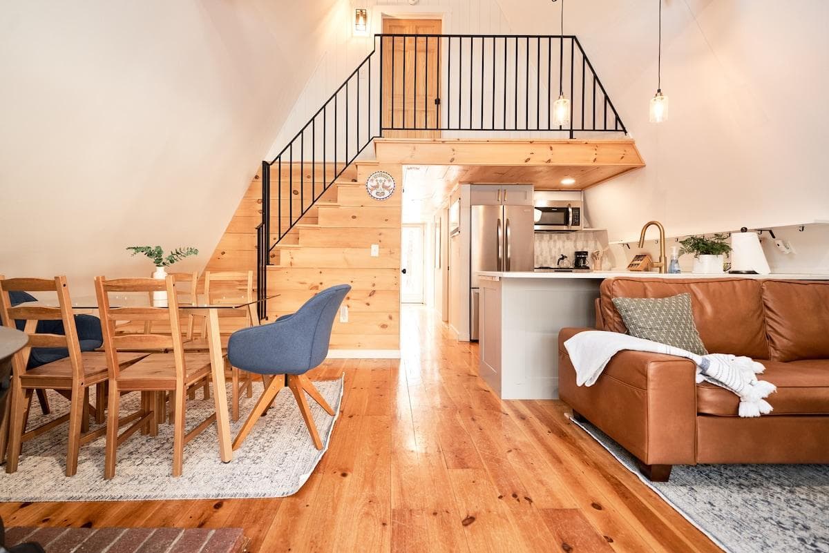 The view right when you walk in the front door. Cozy living room with sofa and chairs, and a dining space that seats 6. The upstairs takes you the cozy Queen loft bedroom. The kitchen is fully stocked!